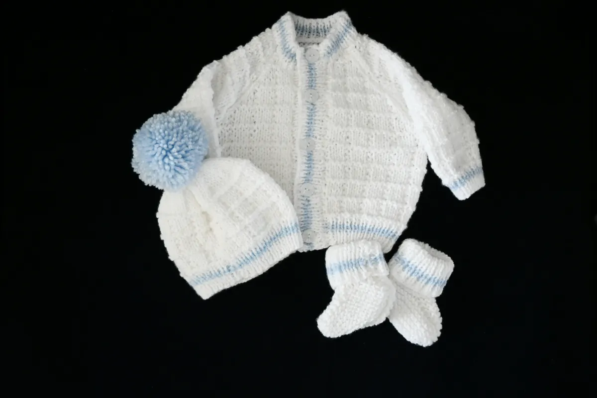 Product: White and Baby Blue Hand-Knitted Cardigan, Hat & Bootees (0-3 months)